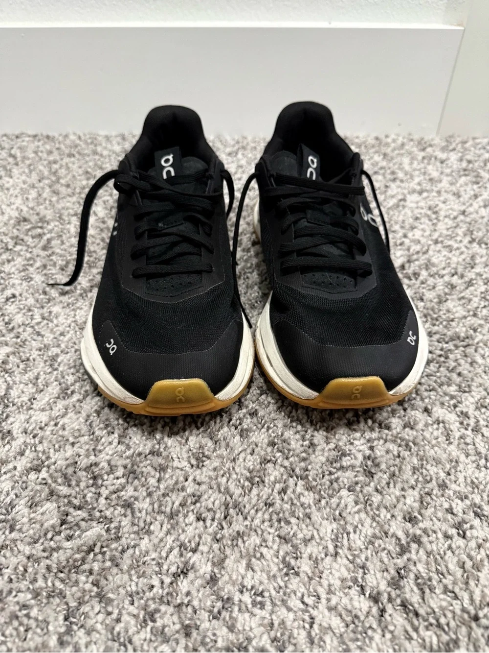 On Running Black Sneakers with Gold Accents